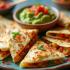 Een bord met kleurrijke quesadillas met guacamole en salsa.
