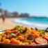 Een traditionele paella gerecht op een strand in Valencia.