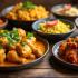 Een verscheidenheid aan kip curry gerechten op een tafel